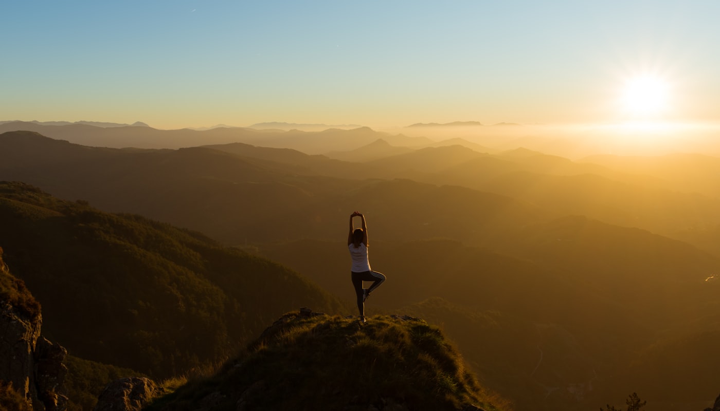 A practitioner stretching at sunrise